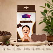 V-Natural Deep Cleansing Coffee Nose Strips packaging box shown on a beige studio background with coffee beans, a bowl, and a plant. The box is brown and white with a photo of a woman wearing a brown nose strip, and a loose brown nose strip is displayed in front.