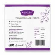 The back of a V-Natural Premium Deluxe Napkins box, showing product details, manufacturing information, and a barcode on a white background with purple accents.