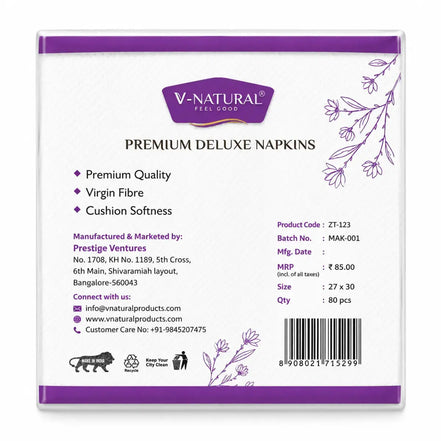 The back of a V-Natural Premium Deluxe Napkins box, showing product details, manufacturing information, and a barcode on a white background with purple accents.