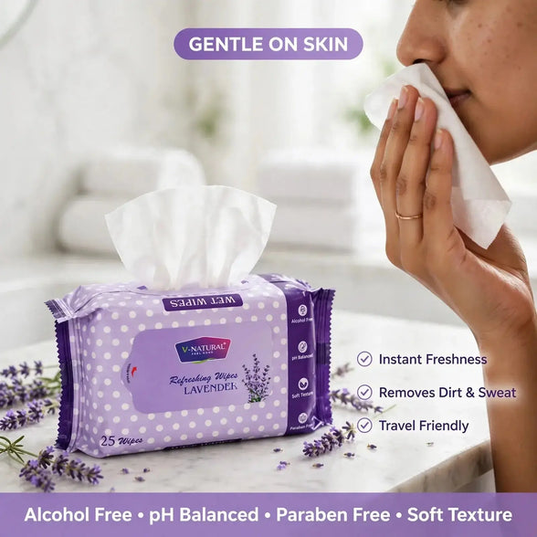 A pack of lavender facial wipes sits on a marble surface with a tissue pulled out, while a woman wipes her nose with a tissue in the background. Text highlights gentle on skin, instant freshness, removal of dirt and sweat, and travel-friendly soft texture