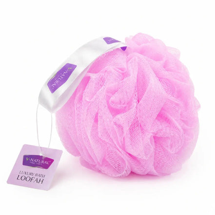 A pink mesh bath loofah with a white and purple ribbon handle and a hanging tag, photographed on a clean white background.